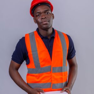 young-african-american-builder-man-wearing-construction-vest-safety-helmet-holding-clipboard